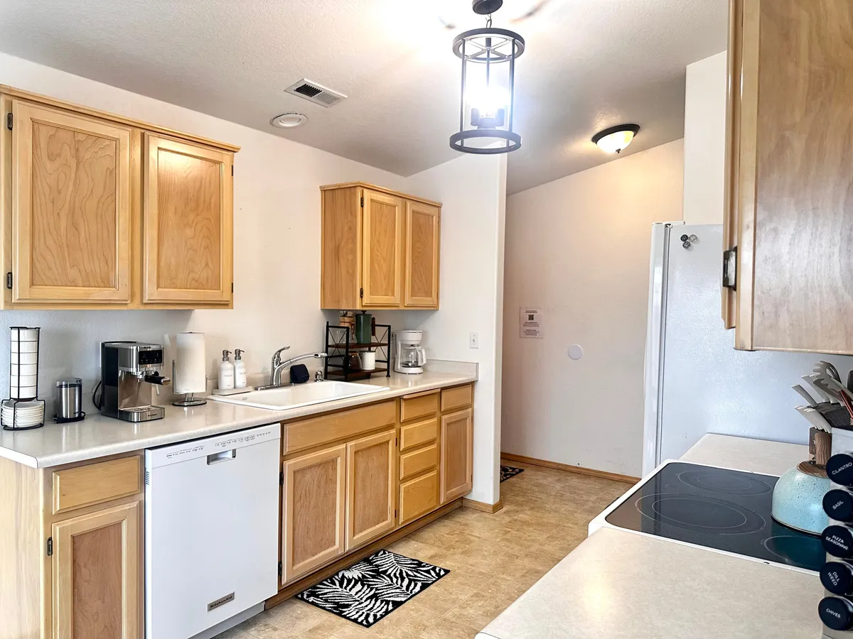 A bright, spacious kitchen with modern cabinetry, sleek countertops, and ample appliances. The setting feels functional yet welcoming, ideal for cooking, entertaining, and gathering for family meals after a day of adventure.